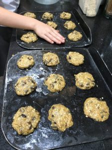 Buzymum - Oat and raisin biscuit dough spaced on a baking sheet